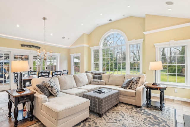 living room with a notable chandelier and lofted ceiling