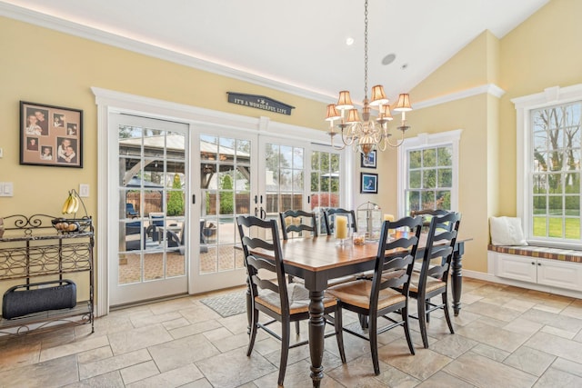 dining room featuring an inviting chandelier, french doors, and vaulted ceiling