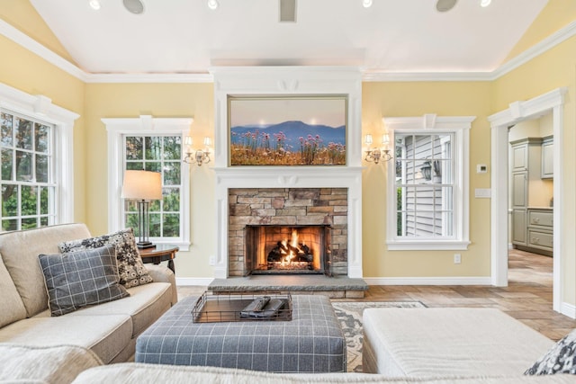 living room featuring ornamental molding, vaulted ceiling, and a stone fireplace