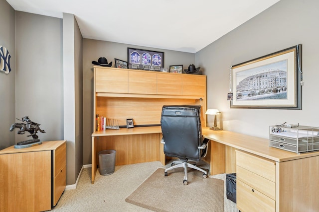 carpeted home office with built in desk