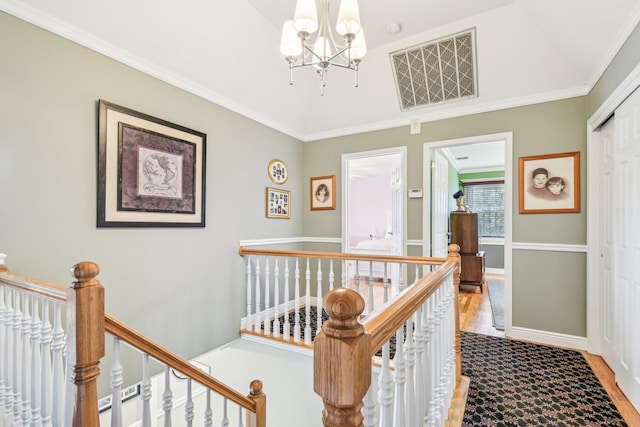 hallway with a chandelier and ornamental molding