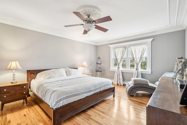 bedroom featuring ceiling fan, light hardwood / wood-style floors, and ornamental molding