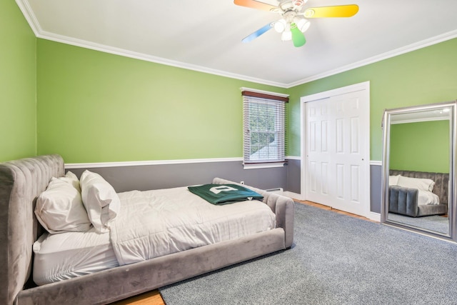 bedroom with ceiling fan, a closet, and crown molding