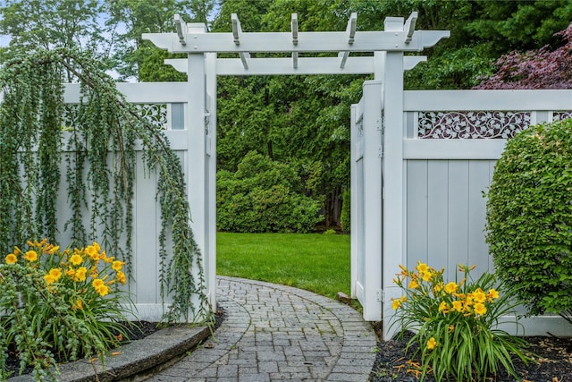 view of gate featuring a yard