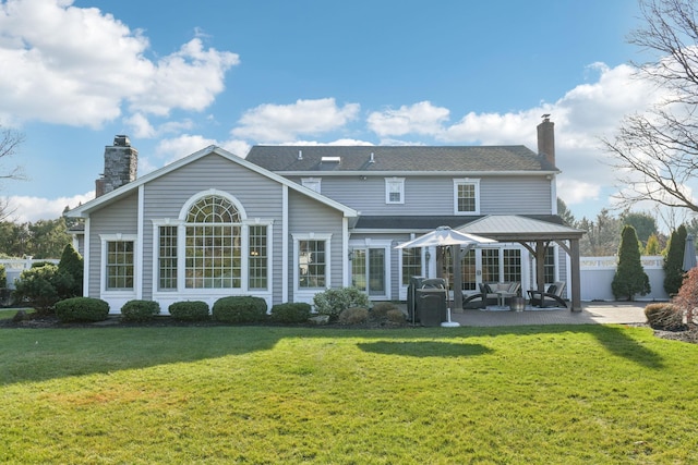 back of property featuring a lawn and a patio area