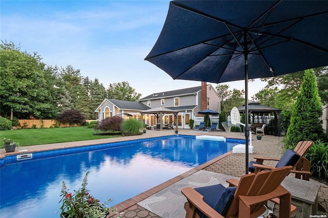 view of swimming pool featuring a gazebo, a yard, and a patio area