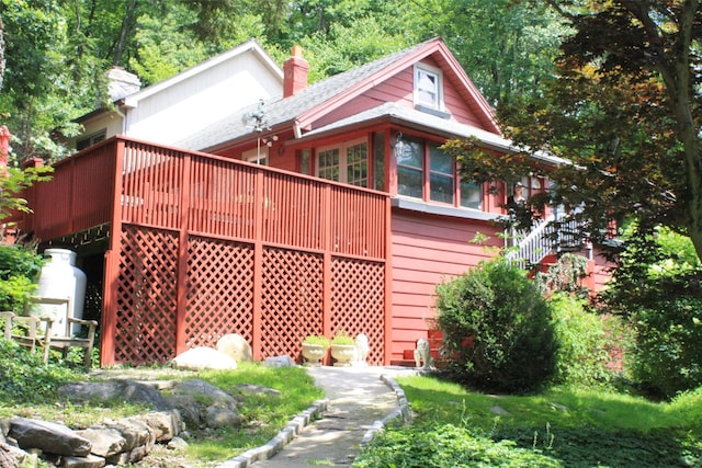 back of property with a chimney