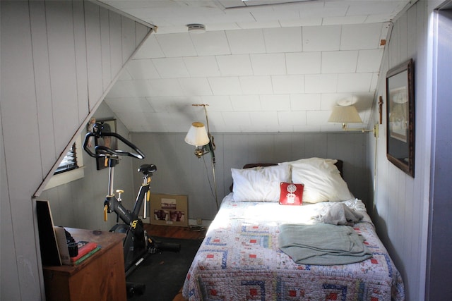 bedroom with wood walls