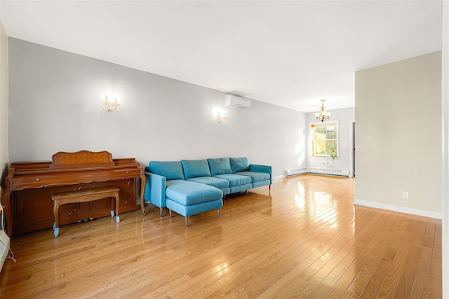 living room featuring a baseboard heating unit, an inviting chandelier, light hardwood / wood-style floors, and a wall mounted air conditioner