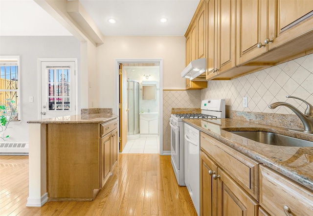 kitchen featuring sink, light hardwood / wood-style flooring, white gas range, and light stone countertops