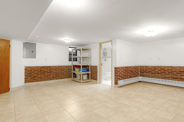 basement featuring electric panel and brick wall