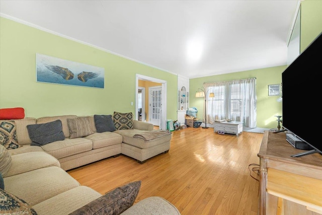 living room featuring crown molding and wood-type flooring