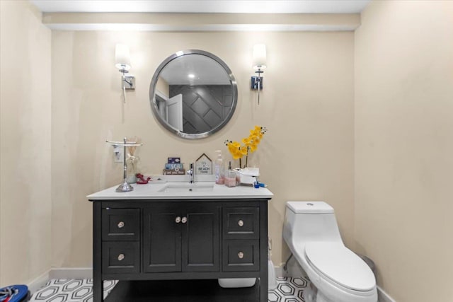 bathroom featuring vanity, toilet, and tile patterned flooring