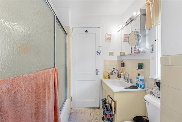 full bathroom featuring vanity, bath / shower combo with glass door, tile patterned floors, and toilet