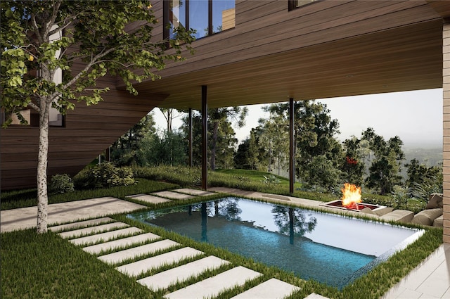 view of pool featuring a patio area and a fire pit