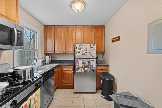 kitchen featuring electric panel, sink, stainless steel appliances, and light tile patterned flooring