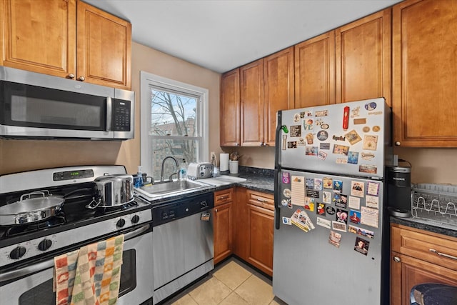 kitchen featuring light tile patterned floors, sink, and appliances with stainless steel finishes