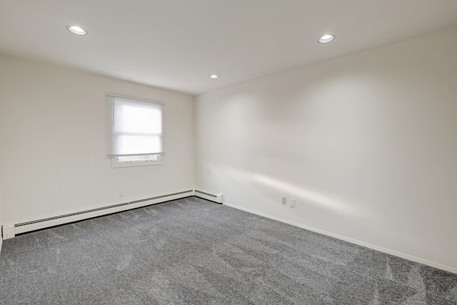 empty room with carpet and baseboard heating