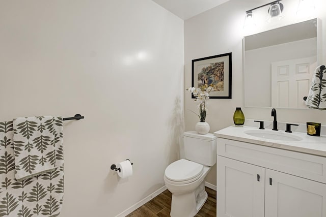 bathroom featuring vanity, wood-type flooring, and toilet