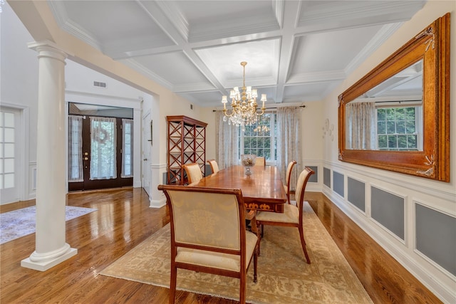 dining space with a chandelier, beam ceiling, decorative columns, and plenty of natural light