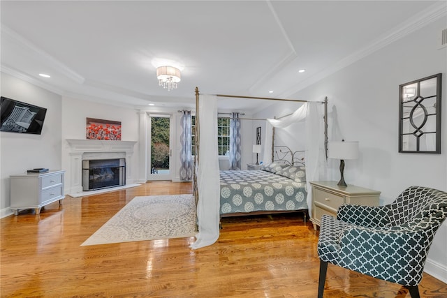 bedroom featuring hardwood / wood-style floors and crown molding