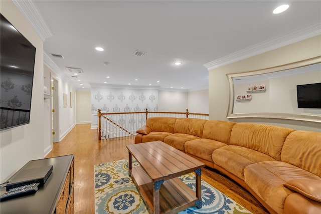 living room with light hardwood / wood-style floors and ornamental molding