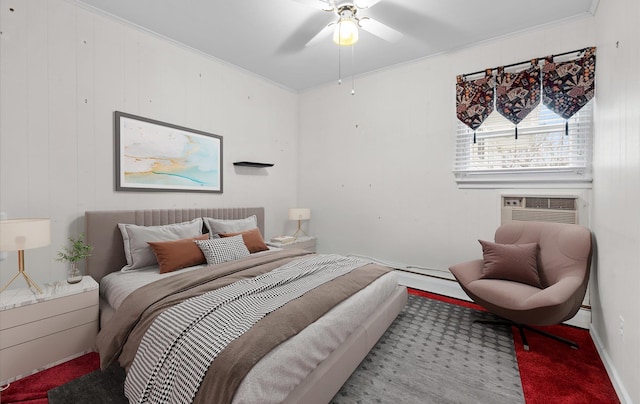 carpeted bedroom featuring a baseboard heating unit, ceiling fan, and crown molding