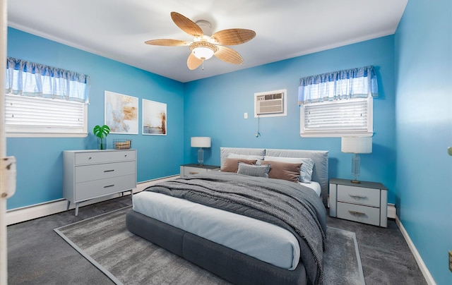 carpeted bedroom with an AC wall unit, baseboard heating, and ceiling fan