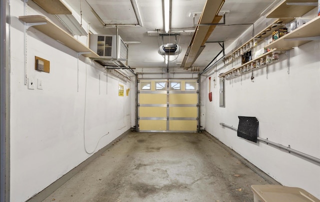 garage featuring electric panel and a garage door opener