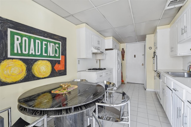 kitchen with white cabinets, white appliances, and sink