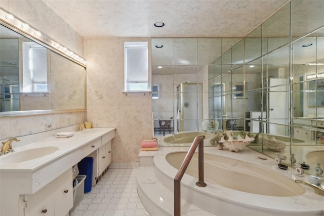 bathroom featuring tile patterned floors, vanity, plenty of natural light, and a tub to relax in