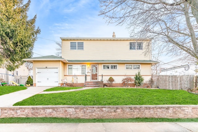 view of front property with a front lawn and a garage