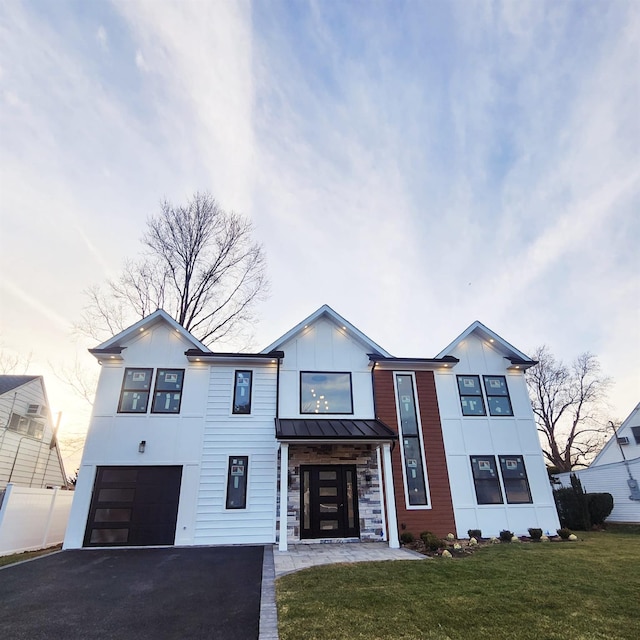 view of front of home featuring a garage and a front lawn