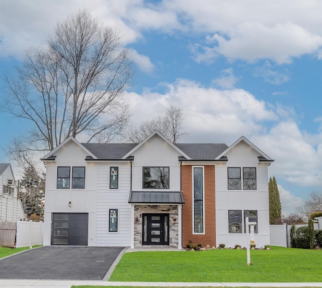 view of front of home featuring a garage and a front yard