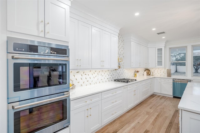 kitchen featuring light stone countertops, white cabinets, and appliances with stainless steel finishes