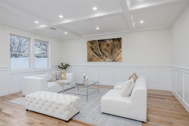 living room with coffered ceiling, beam ceiling, and light hardwood / wood-style flooring