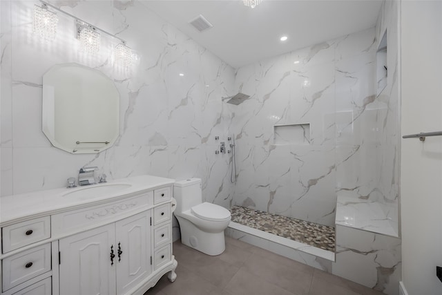 bathroom with a shower, tile walls, vanity, and toilet