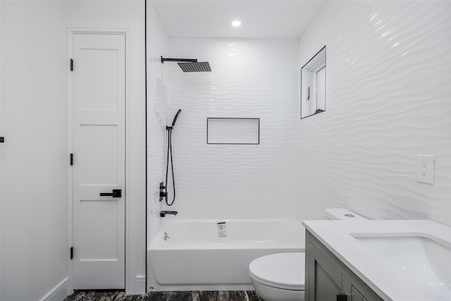 full bathroom featuring tiled shower / bath combo, vanity, and toilet