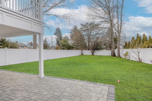 view of yard with a patio and a balcony