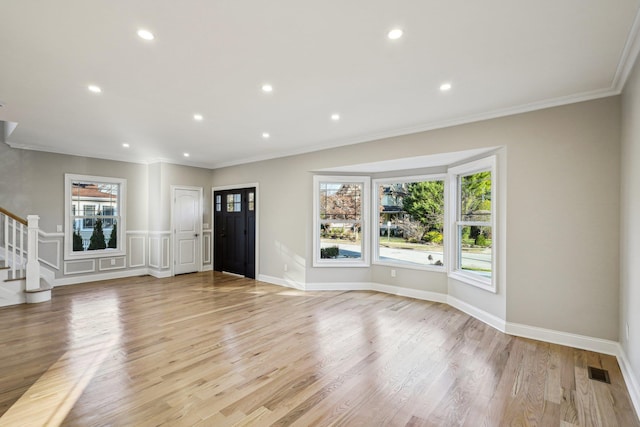 interior space featuring light hardwood / wood-style floors and ornamental molding