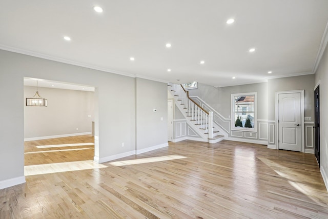 interior space with light hardwood / wood-style flooring and ornamental molding