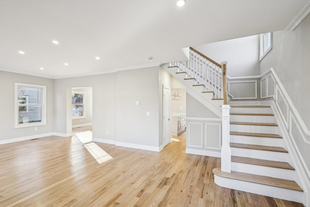 interior space featuring light hardwood / wood-style floors and ornamental molding