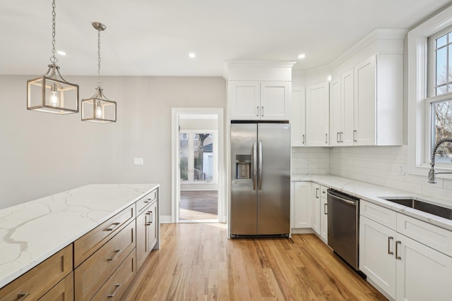 kitchen featuring white cabinetry, pendant lighting, and appliances with stainless steel finishes