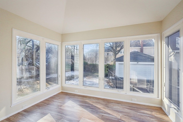 unfurnished sunroom featuring lofted ceiling