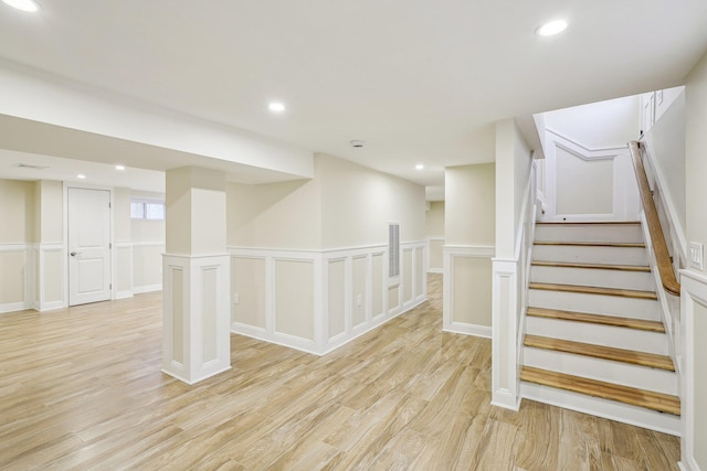 basement with light hardwood / wood-style flooring