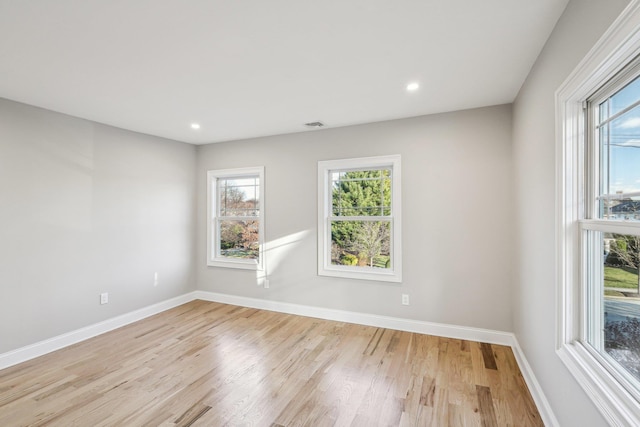 unfurnished room with light hardwood / wood-style floors