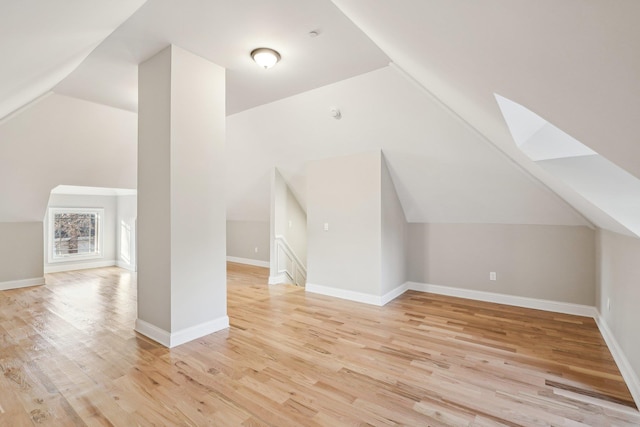 bonus room with light hardwood / wood-style floors and lofted ceiling