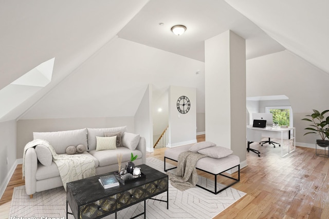 living room featuring vaulted ceiling and light hardwood / wood-style flooring