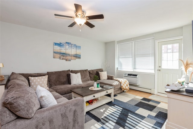 living room featuring baseboard heating, a wall mounted AC, ceiling fan, and light hardwood / wood-style flooring