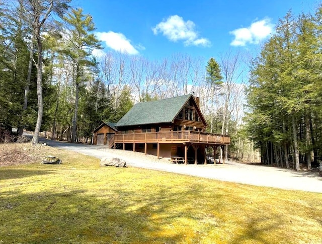 exterior space featuring a lawn and a wooden deck